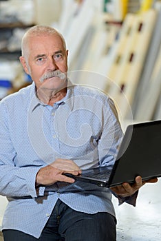 serious senior man working on laptop