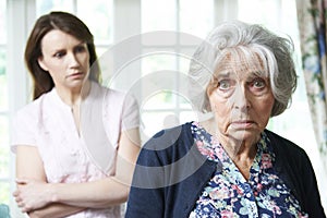 Serious Senior Woman With Worried Adult Daughter At Home