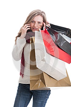 Serious shopping girl talking on smartphone