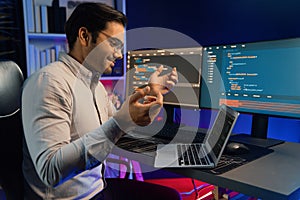 Serious smart IT developer meeting via application team record laptop. Surmise.