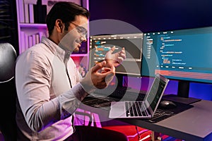 Serious smart IT developer meeting via application team record laptop. Surmise.