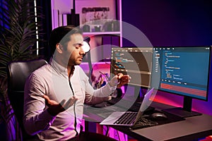 Serious smart IT developer meeting via application team record laptop. Surmise.