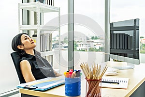 Serious stressed business woman sitting sad and thinking hard how to solve problem in office  company bankruptcy