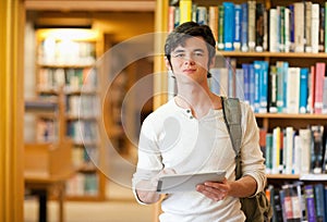 Serious student holding a tablet computer