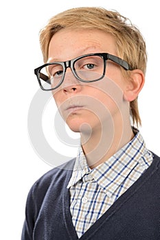 Serious teenage nerd boy wearing geek glasses photo