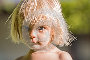 Serious thinking or sad young baby caucasian blonde real people girl close portrait outdoor