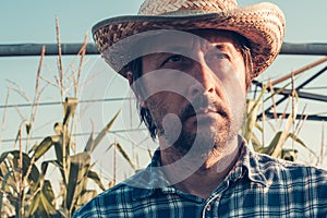 Serious thoughtful farmer in corn field