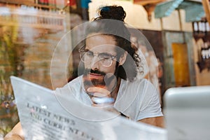 Serious thoughtful man reading an article