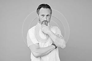 Serious and thoughtful. Serious look of mature man. Bearded man think grey background. Focus thinking. Barbershop. Beard