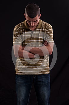 Serious and thoughtful teen boy with hands cross