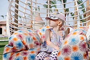 Serious toddler girl on the swing. photo