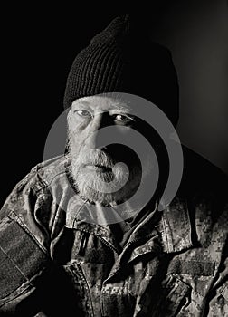 Serious Veteran wearing a camo jacket and knit hat