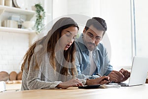 Serious wife and husband planning budget, checking finances