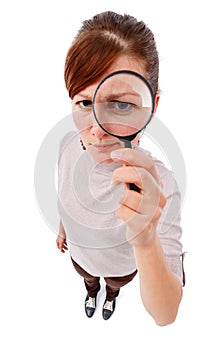 Serious woman as detective with magnifier