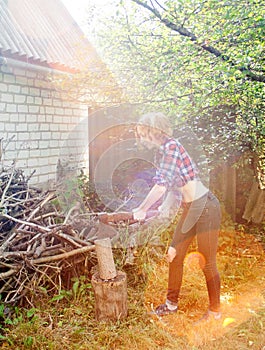 Serious Woman Chopping Wood