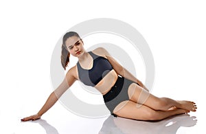 Serious woman doing pilates exercise on floor