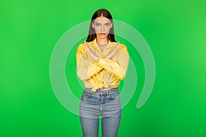 Serious Woman Gesturing Stop Crossing Hands Standing Over Green Background