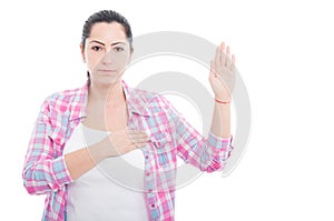 Serious woman giving a gesture of swear