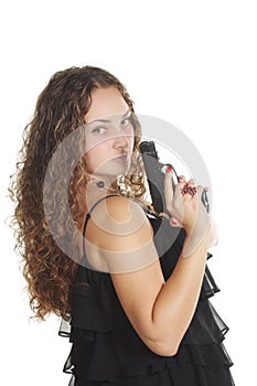 Serious woman with gun looking over shoulder