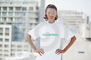 Serious woman with hands on hips wearing volunteer tshirt