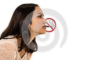 Serious woman looking away with no smoking sign