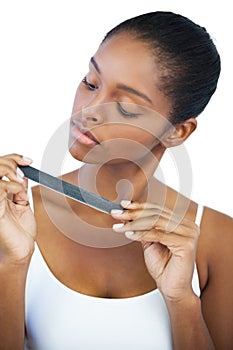 Serious woman looking at her nail file photo