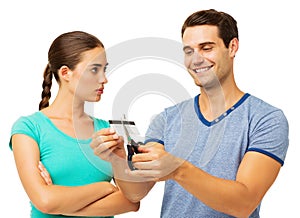 Serious Woman Looking At Man Cutting Credit Card