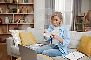 Serious Woman Paying Bills. Worried Lady Calculating And Paying Bills