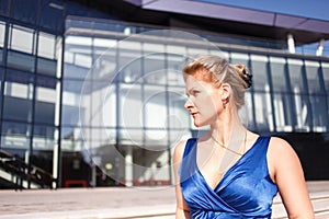 Serious woman portait on business building background
