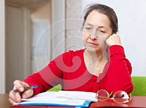 Serious woman reads documents