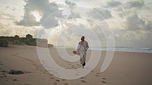 Serious woman running beach on cloudy day. Worried stressed model leaving shot