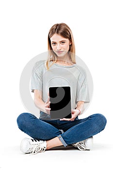 Serious woman showing blank screen of tablet