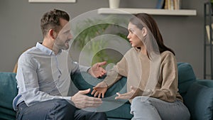 Serious Woman Talking to Man While Sitting on Sofa