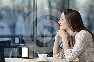 Serious woman thinking in a coffee shop