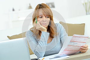 Serious woman thinking about financial issue at home