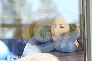 Serious woman thinking looking through a window