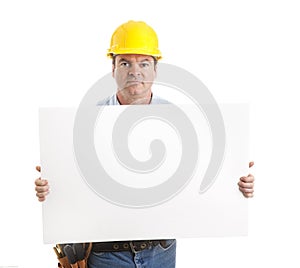 Serious Worker Carries Sign