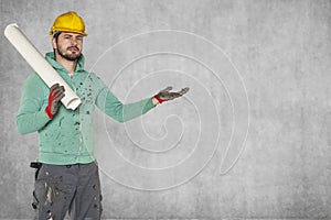 A serious worker with construction plans in his hand