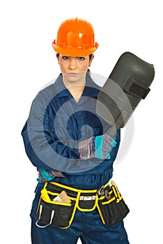 Serious worker woman with welding mask