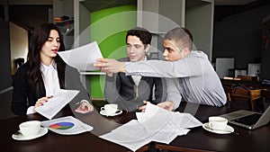 Serious workers and businessmen, two guys and girl discuss about