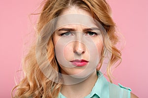 Serious worried woman troubled look gathered brow