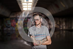 Serious young adult tattooed man subculture