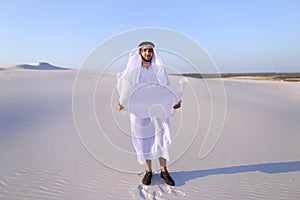 Serious young Arab businessman considering construction plan, st