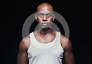Serious young black man in undershirt