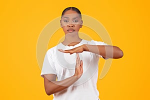 Serious Young Black Woman Showing Time Out Hand Gesture, Studio