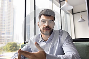 Serious young business professional man talking on video call