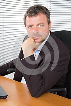 serious Young businessman sitting in office desk