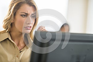 Serious Young Businesswoman Working On Computer