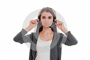 Serious young call center office girl with headphones and microphone looking at the camera isolated on white background