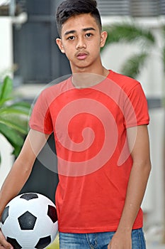 Serious Young Diverse Person With Soccer Ball